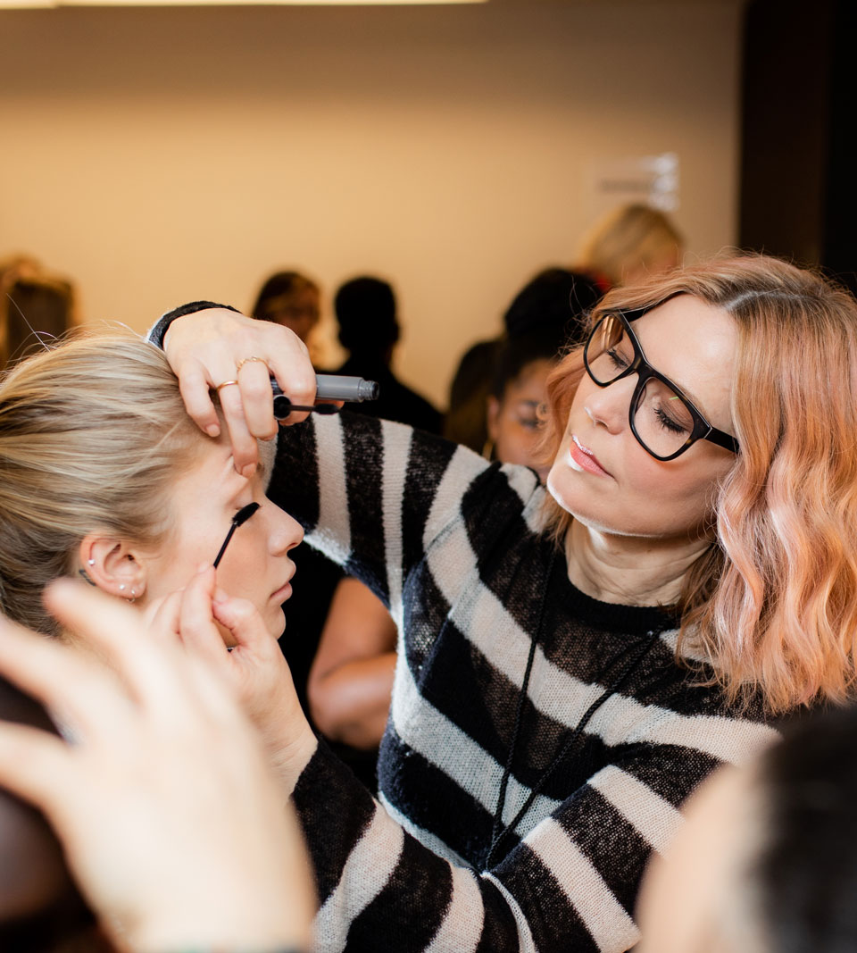 woman applying makeup on someone