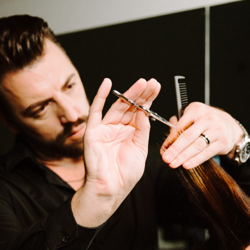 close shot of man cutting hair in beauty school