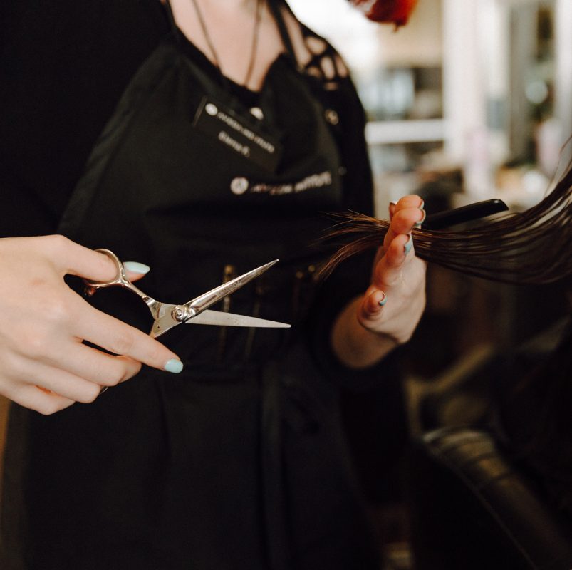 up-close shot of beauty school student cutting hair
